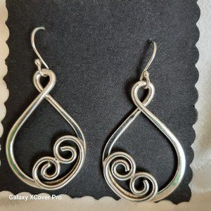Silver Tear drop shaped earrings with scroll work for pierced ears